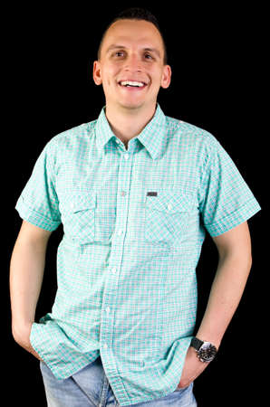 Young business man smiling in studio isolated on blackの写真素材