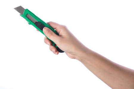 Hand holding paper cutter isolated on white backgroundの写真素材