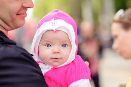 Dad keeps on hand a small child. A family walk in the spring in the Park. The plan. A blurred...