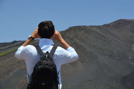 Young man with a backpack on Mount Etna.の写真素材