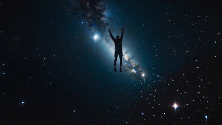 Silhouette of a man with raised hands against the background of the Milky Wayの素材
