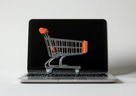 Laptop with shopping cart on white background. Online shopping concept.の素材