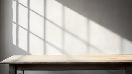 Empty wooden table and shadow on white wall background. For product displayの素材