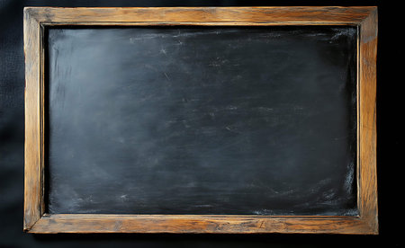 Empty blackboard with wooden frame on a black background. Copy spaceの素材