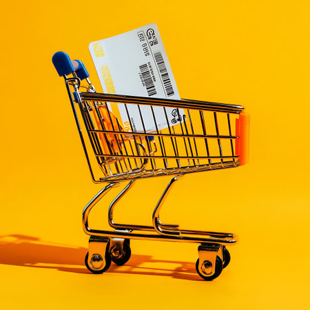 Shopping cart with credit card on yellow background. Online shopping concept.の素材