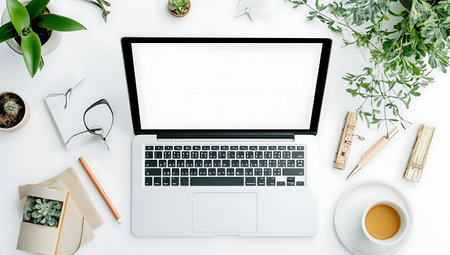 Flat lay, top view office workspace with laptop, coffee cup, plant and stationery.の写真素材