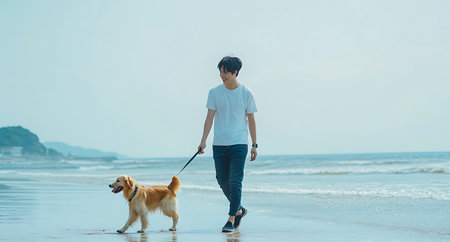 A person walking with their dog on the beach in the morningの写真素材