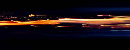 Abstract background with blurred light trails in the form of waves. Long exposure.の写真素材