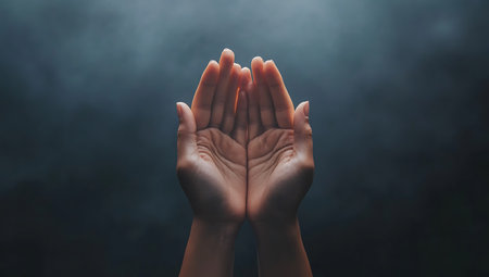 Hands of woman praying on dark background with smoke. Prayer conceptの写真素材