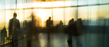 Silhouettes of business people walking in the lobby of a modern office buildingの写真素材