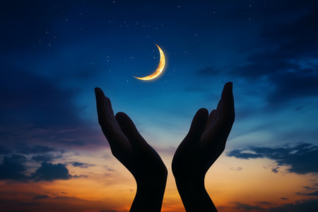 Hands holding a crescent moon in the night sky. The concept of religionの写真素材