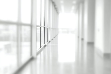 Interior of a corridor with white walls and large windows.の素材