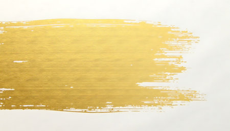 Gold paint brush stroke on white paper background. Abstract art background.の写真素材