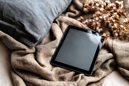 Tablet pc with blank screen on the bed in the bedroom.の写真素材
