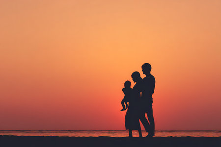 Silhouette of a happy family on the beach at sunset.の写真素材
