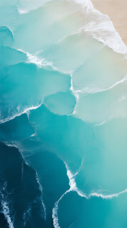 Aerial view of a turquoise ocean with white foam.の写真素材