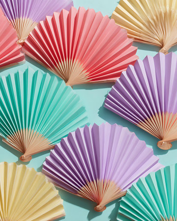 Colorful paper fans on blue background. Flat lay, top viewの写真素材