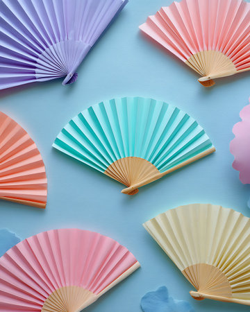 Colorful paper fans on blue background. Flat lay, top viewの写真素材