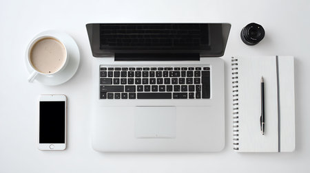 Top view of laptop, smartphone, notebook and cup of coffee on white backgroundの写真素材