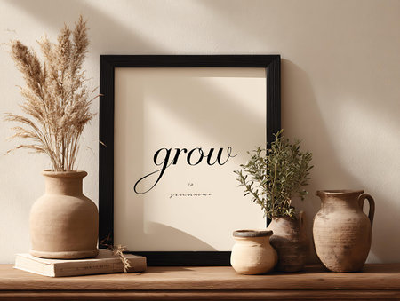 Frame mockup with dried flowers in vase on wooden table over white wallの写真素材