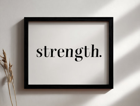 Black wooden frame with text in black frame on white wall with shadow.の写真素材