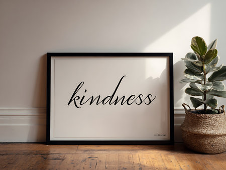 Mock up frame with the word kindness in front of a white wallの写真素材