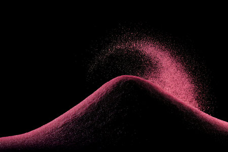 Pink sand explosion isolated on black background. Abstract cloud of dust.の写真素材