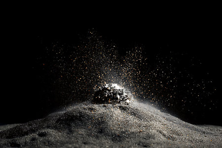 Conceptual image of sand explosion on black background. Mixed mediaの写真素材
