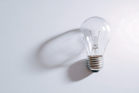 Light bulb on a white background with shadow and copy space for textの写真素材