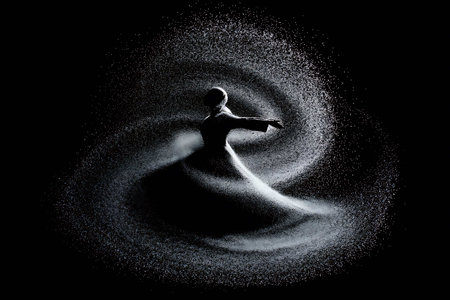 Silhouette of a man in a spray of water on a black backgroundの写真素材