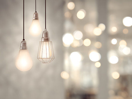 Vintage light bulbs hanging on the ceiling with bokeh backgroundの写真素材