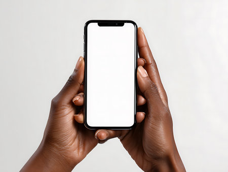 Female hands holding a smartphone with a blank screen on a white backgroundの写真素材