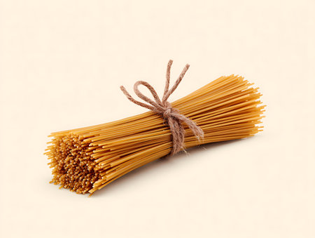 Bunch of spaghetti tied with twine on a white background.の写真素材