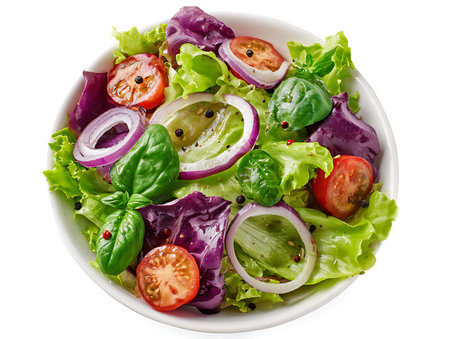 Salad with lettuce, tomato, onion and basil isolated on white backgroundの写真素材