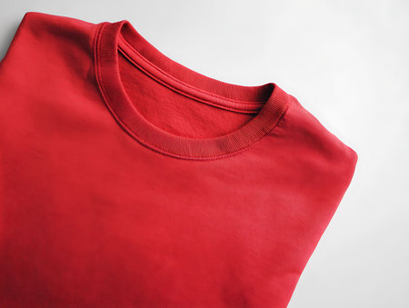 Red T-shirt isolated on white background. Clipping path included.の写真素材