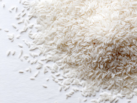 Close up of rice grains on white background. Top view with copy space.の写真素材