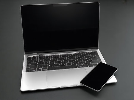 Laptop with blank screen and mobile phone on grey background. 3d renderの写真素材