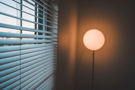 Close up of window blinds and a lamp in the morning.の写真素材