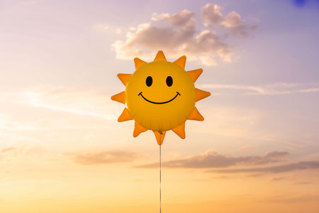Smiling sun on the sky with clouds background. Summer concept.の写真素材