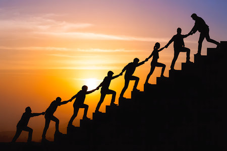 Silhouette of business people pulling a rope to reach the goalの写真素材