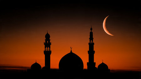 Ramadan Kareem background with mosque and crescent moon at sunsetの写真素材