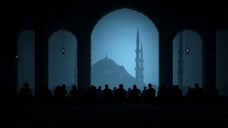 Silhouette of Muslim people praying in front of the mosque at nightの写真素材