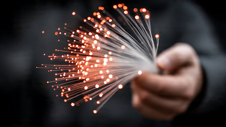 Close up of businessman holding bunch of optical fibers flying from handの写真素材