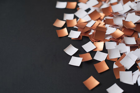 Paper confetti on black background. Festive concept. Copy space.の写真素材