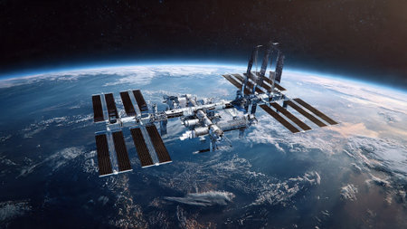 Space station with solar panels orbiting Earth, showing planet's curvature and atmosphereの写真素材