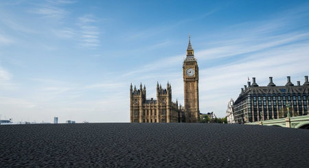 The iconic Big Ben clock tower stands tall against a serene blue sky in Londonの写真素材