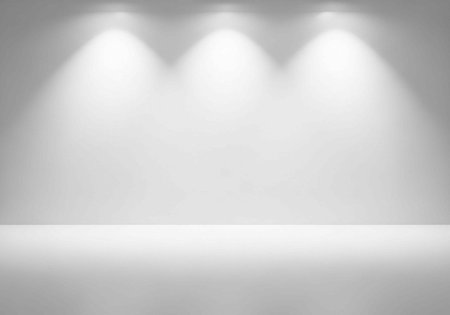 A brightly lit empty stage with spotlights shining down on a blank white floor and wallの写真素材