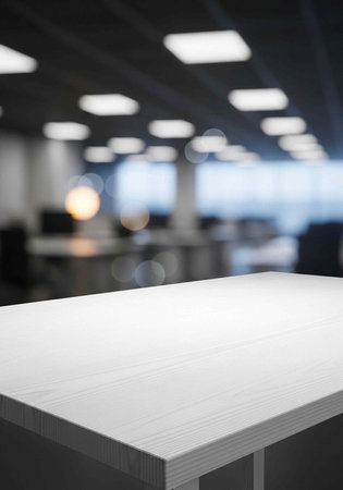 A modern office space with a large empty table in the foreground and blurred backgroundの写真素材