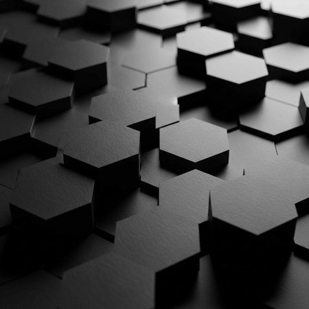 Close-up of black hexagonal blocks arranged in a pattern, creating a textured background with shadows and depth.の写真素材