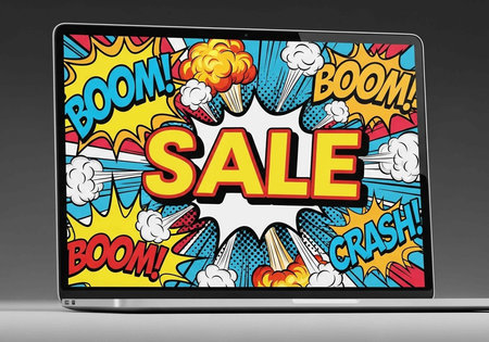 A colorful comic-style laptop screen displays a vibrant sale advertisement with bold graphics and textの写真素材